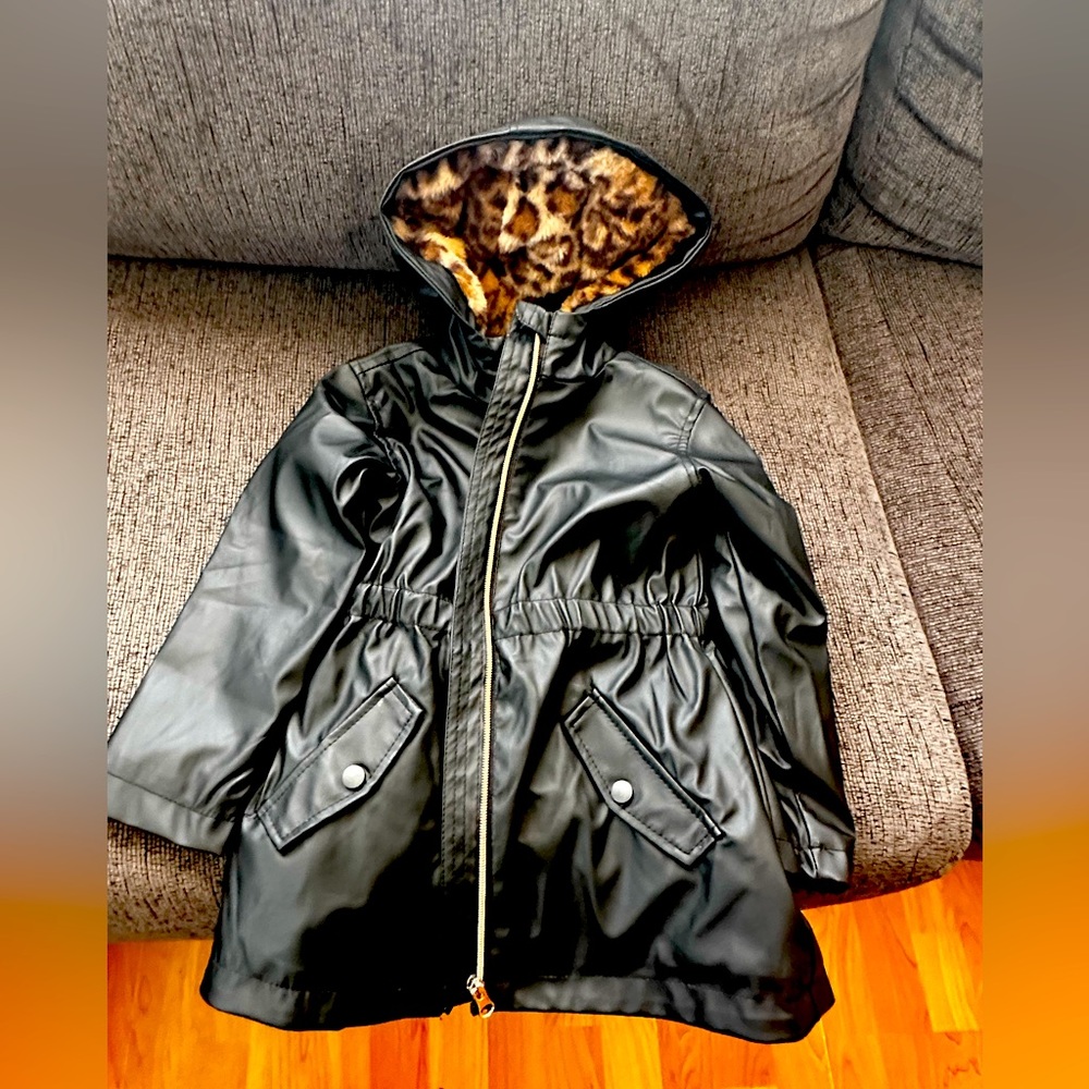 Black rain coat with soft leopard print material inside.